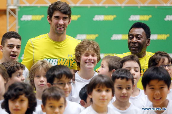 U.S. former Olympic swimmer, Michael Phelps (2nd-L-Rear), and former Brazilian soccer player Edson Arantes do Nascimiento 'Pele' (R-Rear), pose durinng a press conference of a promotional event in Sao Paulo, Brazil, on Dec. 4, 2013.