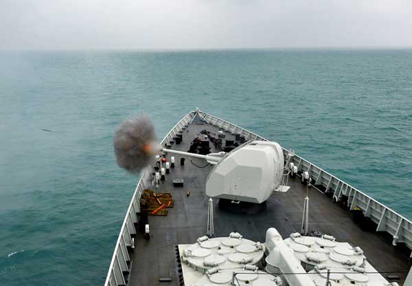 Smoke billows from the Haikou's main deck gun during a training exercise. [China Daily]