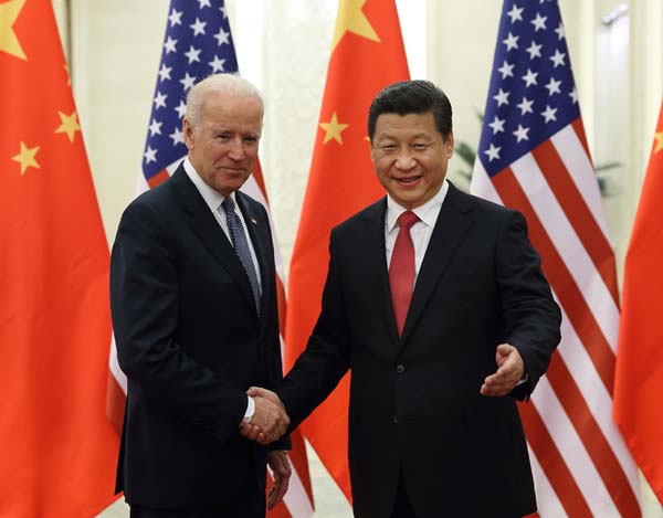 Chinese President Xi Jinping (R) shakes hands with US Vice President Joe Biden during their meeting at the Great Hall of the People in Beijing, capital of China, Dec. 4, 2013. [Photo/Xinhua]