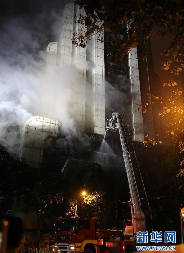 Fire was raging in a high-rise building in downtown Guangzhou, capital of south China's Guangdong Province, on Sunday night. [Photo / Xinhua]