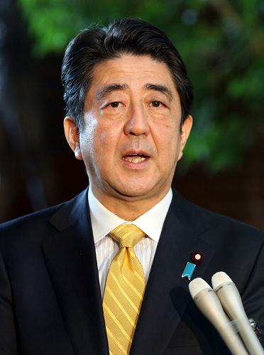 Japanese Prime Minister Shinzo Abe speaks to the press after a cabinet meeting at his office in Tokyo on December 17, 2013. [Xinhua photo]