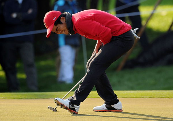 Liang Wenchong of Asia reacts after missing a birdie putt on the 16th hole during the Royal Trophy singles matches in Guangzhou, south China, yesterday. 