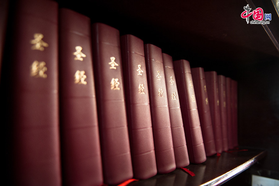 The Church of the Saviour (colloquially referred to as Xishiku Church, or Beitang -- the North Cathedral) in Beijing keeps a stack of Holy Bibles on Dec. 25, 2013, in a bid to facilitate church-goers who forget to bring theirs. [Photo by Chen Boyuan / China.org.cn]