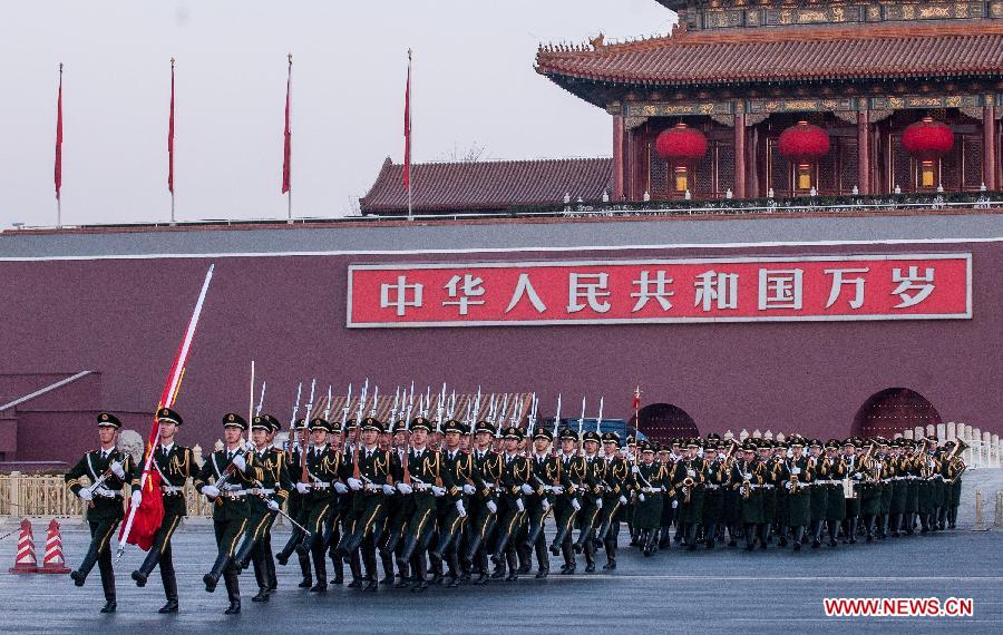 Chinese national flag guards escort the flag across the Chang'an Avenue in Beijing, capital of China, Jan. 1, 2014. Nearly 20,000 people gathered at the Tian'anmen Square and witnessed the national flag raising ceremony on the first day of the new year. (Xinhua/Zhang Yu)