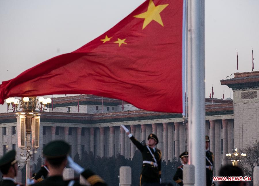 Chinese national flag rises at the Tian'anmen Square in Beijing, capital of China, Jan. 1, 2014. Nearly 20,000 people gathered at the Tian'anmen Square and witnessed the national flag raising ceremony on the first day of the new year. (Xinhua/Zhang Yu)