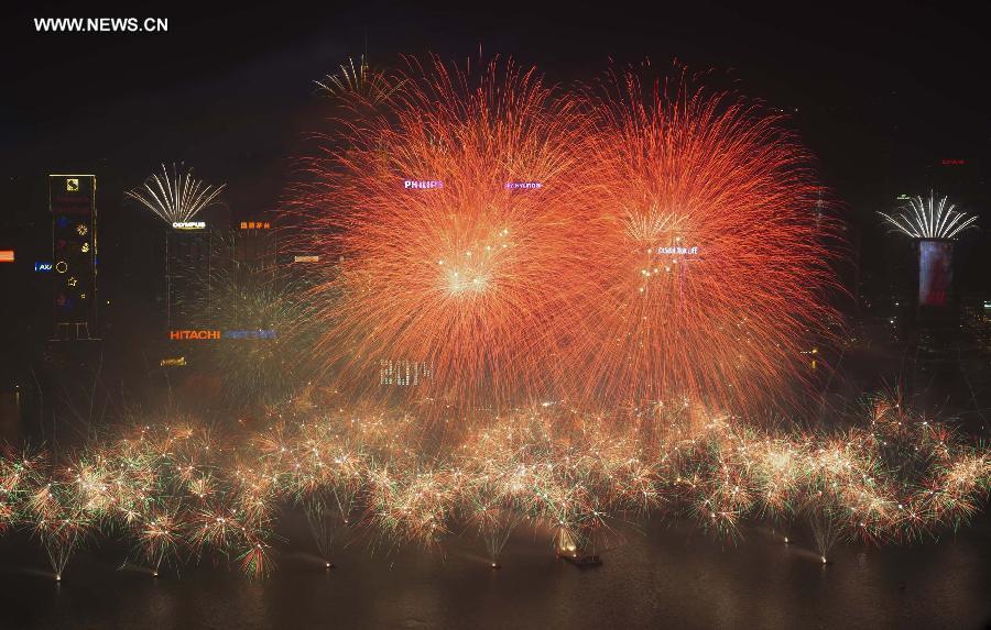 Fireworks explode over the Victoria Harbor during a new year celebration in Hong Kong, south China, Jan. 1, 2014. (Xinhua/Lui Siu Wai)