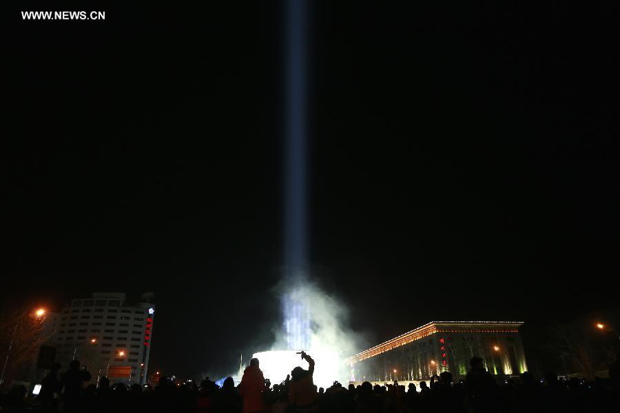 An 11-meter-diameter light pole, which is called Light of Beijing, is shown at the China Millennium Monument in Beijing, to welcome the coming of new year on Jan. 1, 2014. (Xinhua/Li Mingfang)