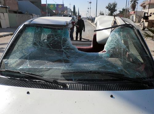 The roof of vehicle is partially destroyed following of a suicide car bomb that detonated outside a central police station in the northern Iraqi city of Kirkuk on January 7, 2014, killing two people and wounding some 52 others. The United States said it would speed up its deliveries of missiles and surveillance drones to Iraq as the Baghdad government battles a resurgence of Al-Qaeda linked militants further south in the country. [Xinhua photo]
