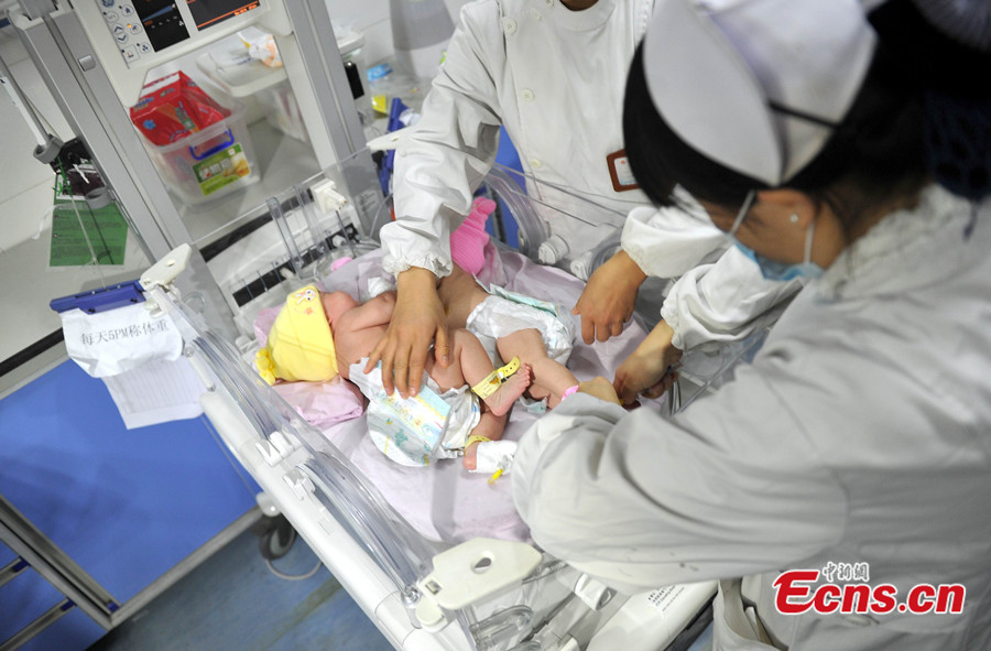 A pair of Chinese conjoined twin sisters, who shared the same liver, are developing normally according to their first hospital checkup since they were separated in August 2013, a hospital source said Tuesday. [CNS photo]