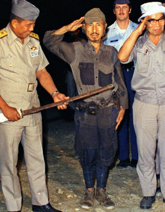 Hiroo Onoda salutes his commander Taniguchi Yoshimi who returns the salute and reads out the surrender order to Onoda. Thereupon, Onoda took off his weapons and walked straight into the Lubang Island Police Station.