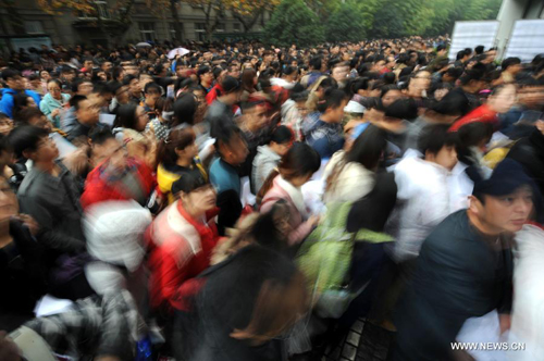 Candidates walk into an exam site in Nanjing, capital of east China's Jiangsu Province, November 24, 2013. National-level government agencies, their affiliated public institutions and local branches will recruit 19,000 civil servants in 2014. [Xinhua]