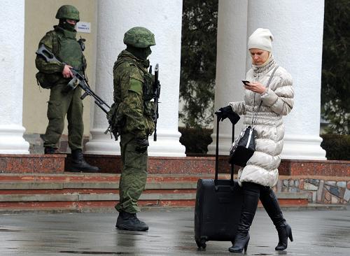 Unidentified armed men patrol outside of Simferopol airport, on February 28, 2014. [Xinhua photo]