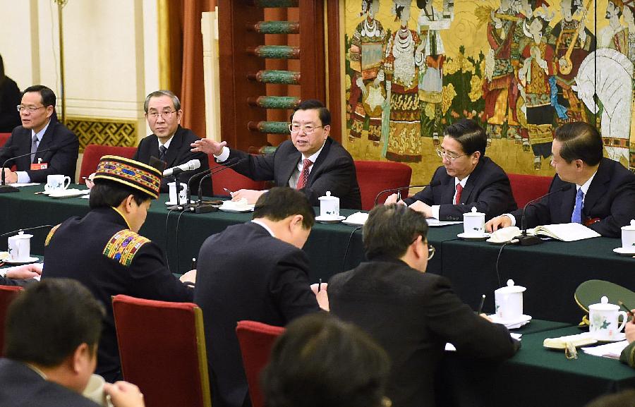 Zhang Dejiang (C, rear), chairman of the Standing Committee of China&apos;s National People&apos;s Congress (NPC) and a member of the Standing Committee of the Political Bureau of the Communist Party of China (CPC) Central Committee, joins a discussion with deputies to the 12th NPC from south China&apos;s Guangxi Zhuang Autonomous Region during the second session of the 12th NPC, in Beijing, capital of China, March 9, 2014. 