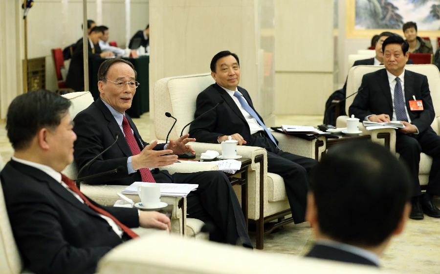 Wang Qishan (2nd L), a member of the Standing Committee of the Political Bureau of the Communist Party of China (CPC) Central Committee and secretary of the CPC Central Commission for Discipline Inspection, joins a discussion with deputies to the 12th National People&apos;s Congress (NPC) from northwest China&apos;s Shaanxi Province during the second session of the 12th NPC, in Beijing, capital of China, March 9, 2014. 