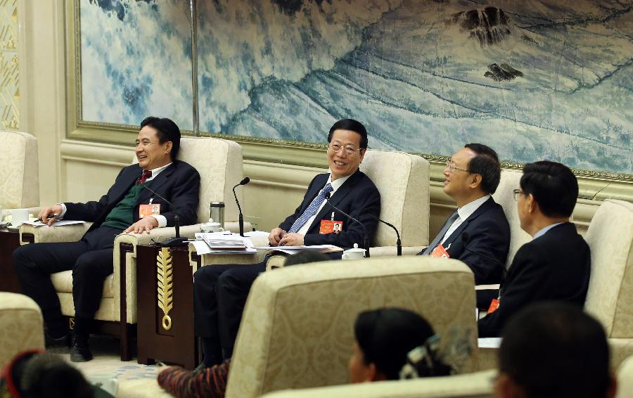 Chinese Vice Premier Zhang Gaoli (2nd L), also a member of the Standing Committee of the Political Bureau of the Communist Party of China Central Committee, joins a discussion with deputies to China&apos;s 12th National People&apos;s Congress (NPC) from south China&apos;s Hainan Province during the second session of the 12th NPC, in Beijing, capital of China, March 9, 2014. 