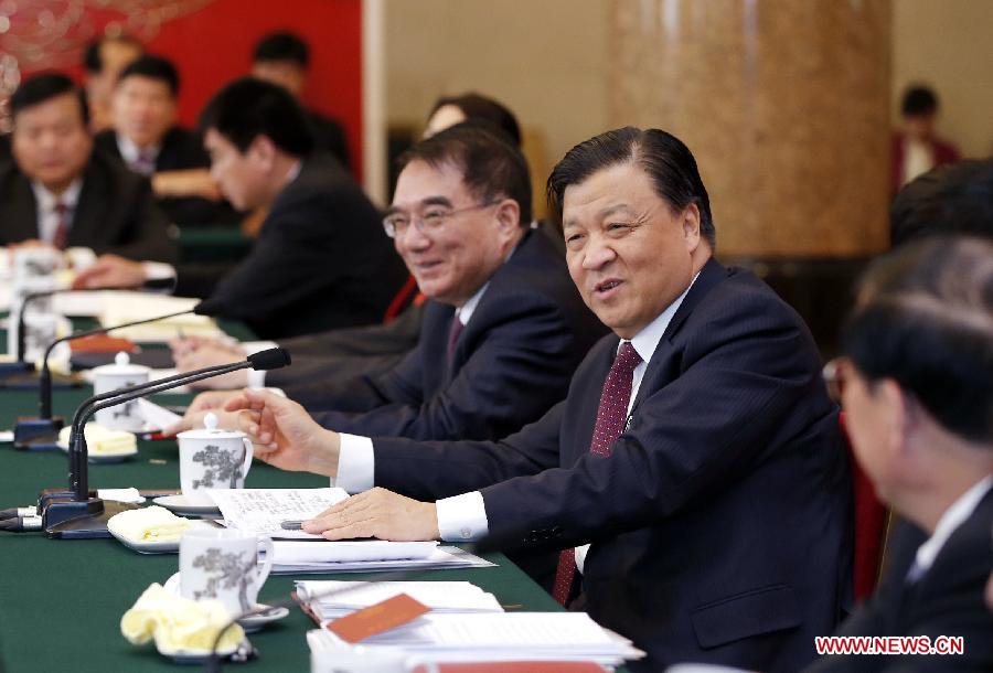 Liu Yunshan (2nd R), a member of the Standing Committee of the Political Bureau of the Communist Party of China (CPC) Central Committee and secretary of the Secretariat of the CPC Central Committee, joins a discussion with deputies to the 12th National People's Congress (NPC) from northeast China's Liaoning Province during the second session of the 12th NPC, in Beijing, capital of China, March 10, 2014.[Photo/Xinhua]