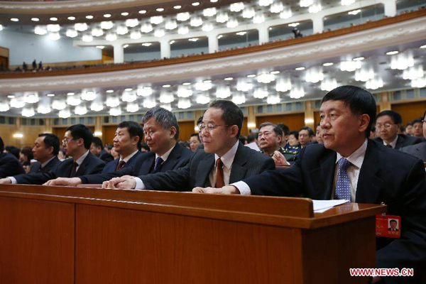 Members of the 12th National Committee of the Chinese People's Political Consultative Conference (CPPCC) attend the closing meeting of the second session of the 12th CPPCC National Committee in Beijing, capital of China, March 12, 2014.