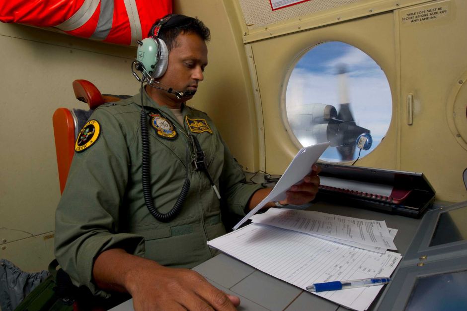 A Royal Australian Air Force tactical coordinator runs the search for flight MH370 in an AP-3C Orion. [Australian Defence Force:Hamish Paterson]