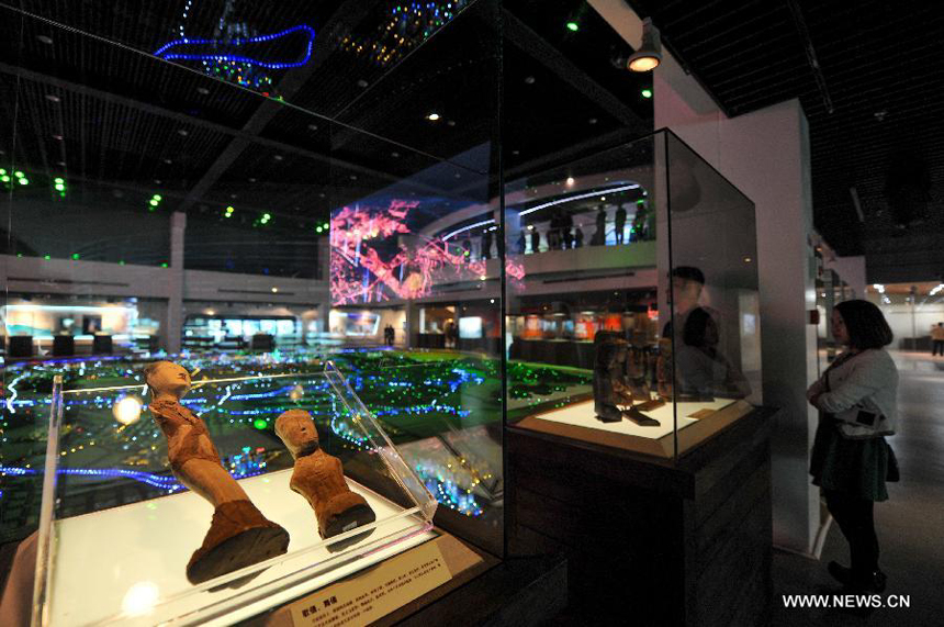 Visitors watch the displayed cultural relics at Hunan Provincial Museum in Changsha, capital of central China&apos;s Hunan Province, March 28, 2014. More than 50 pieces (sets) of cultural relics from the Mawangdui Tombs of the Han Dynasty (206 B.C. - 220 A.D.), located in the eastern suburbs of Changsha, will be officially re-presented at the museum from March 29.