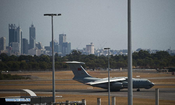 A Chinese Air Force plane returns to the International Airport of Perth in Australia, March 28, 2014. Australian search and rescue authorities announced Friday they had relocated the search for Malaysia Airlines flight MH370 to an entirely new area after receiving its most credible lead to date. 