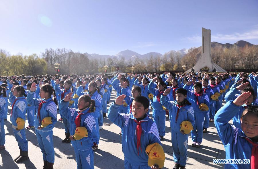 Students attend a flag-raising ceremony celebrating the 55th anniversary of serfs&apos; emancipation in Lhasa, capital of southwest China&apos;s Tibet Autonomous Region, March 28, 2014