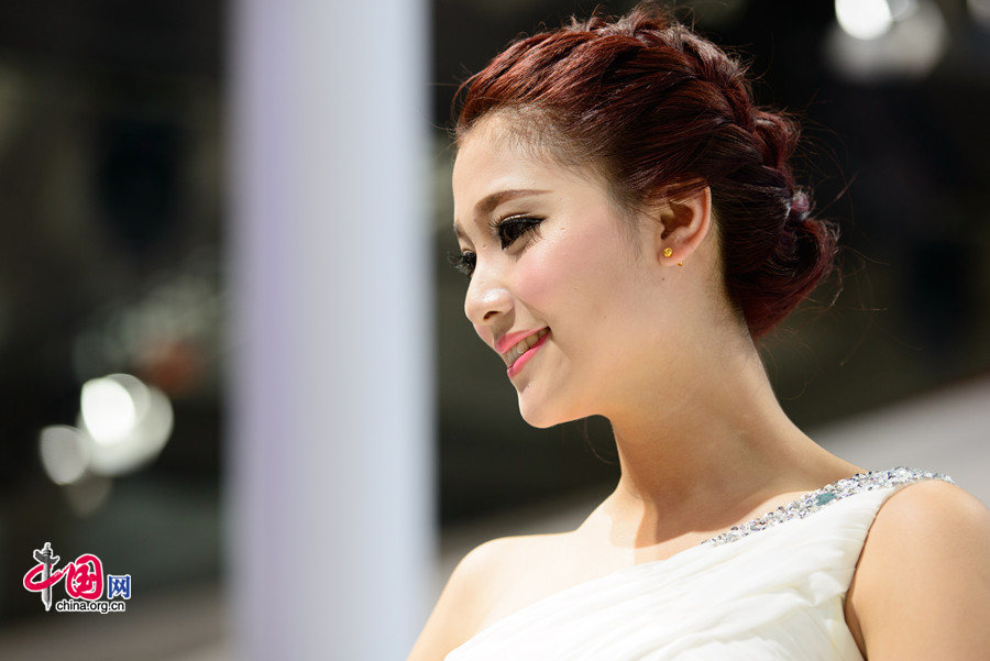 A car model poses for photo on Monday, April 21, 2014, at the 2014 Beijing International Automotive Exhibition, which officially opens to public on this day. The auto expo will last until April 29. [Photo by Chen Boyuan / China.org.cn]