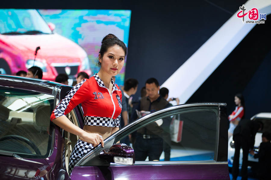 A car model poses for photo on Monday, April 21, 2014, at the 2014 Beijing International Automotive Exhibition, which officially opens to public on this day. The auto expo will last until April 29. [Photo by Chen Boyuan / China.org.cn]