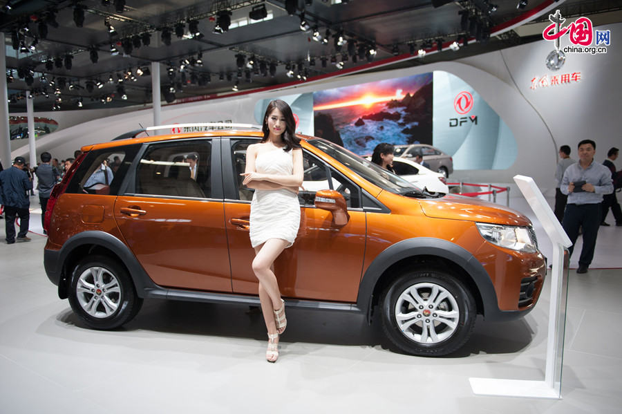 A car model poses for photo on Monday, April 21, 2014, at the 2014 Beijing International Automotive Exhibition, which officially opens to public on this day. The auto expo will last until April 29. [Photo by Chen Boyuan / China.org.cn]