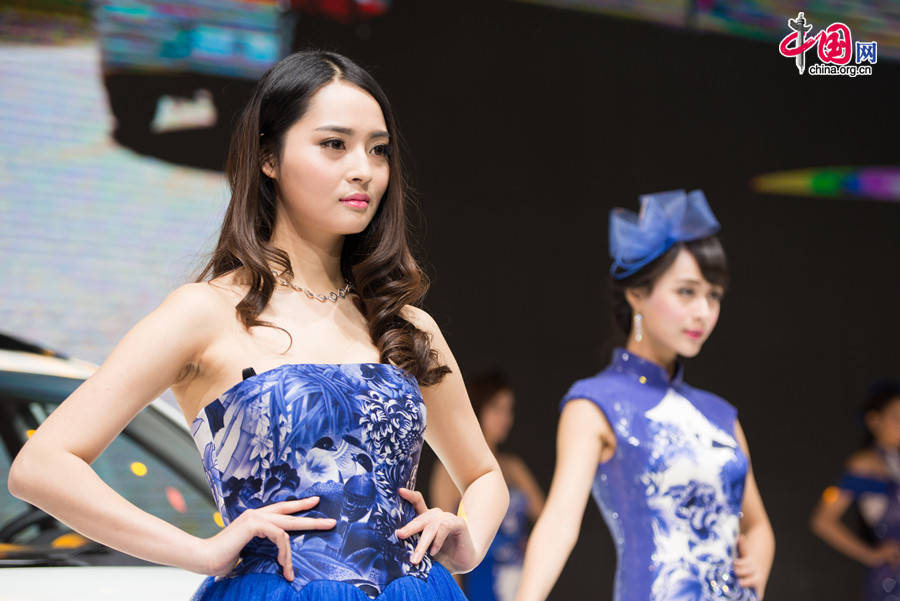 A car model poses for photo on Monday, April 21, 2014, at the 2014 Beijing International Automotive Exhibition, which officially opens to public on this day. The auto expo will last until April 29. [Photo by Chen Boyuan / China.org.cn]