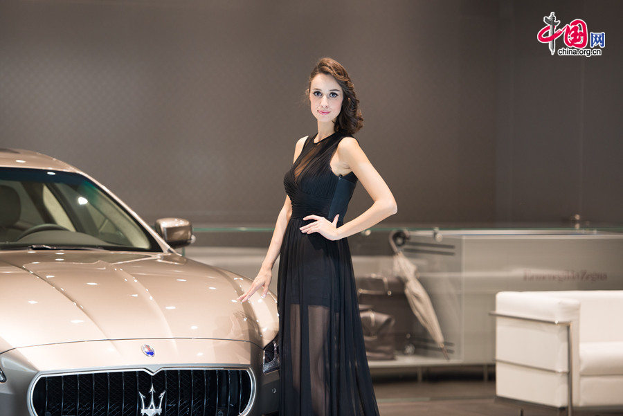 A car model poses for photo on Monday, April 21, 2014, at the 2014 Beijing International Automotive Exhibition, which officially opens to public on this day. The auto expo will last until April 29. [Photo by Chen Boyuan / China.org.cn]