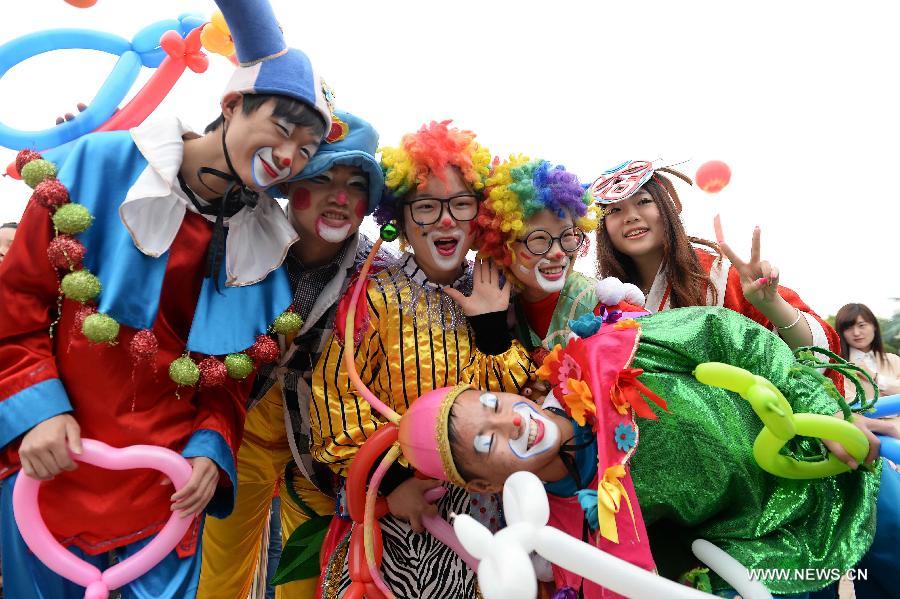 Clowns pose for photos at the Fantawild Adventure amusement park, in Wuhu, east China&apos;s Anhui Province, April 28, 2014. Many people in Wuhu went to amusement parks to enjoy spring outdoors. 
