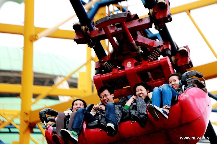 Tourists experience a recreation program at the Fantawild Adventure amusement park in Wuhu, east China&apos;s Anhui Province, April 28, 2014. Many people in Wuhu went to amusement parks to enjoy spring outdoors.