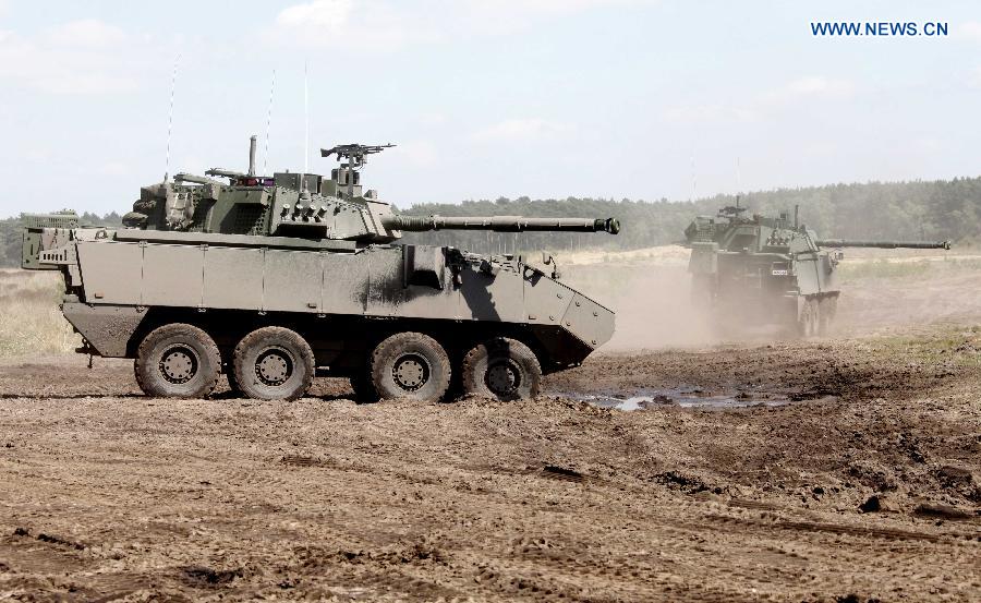 Armored fighting vehicles take part in a joint exercise in Leopoldsburg, Belgium, on May 16, 2014.