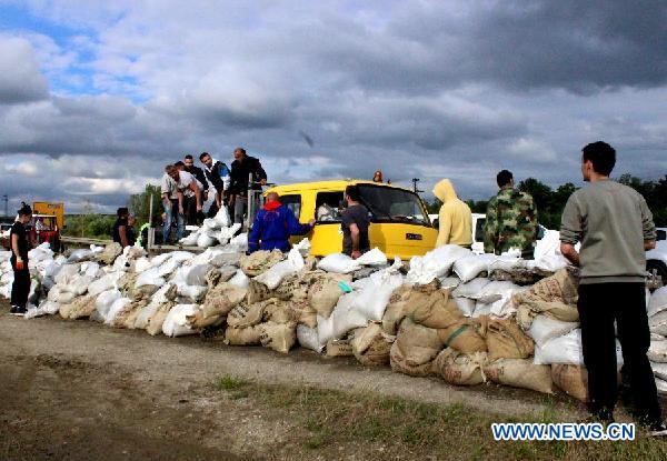 People build embankments by filling sacks with sand and building them into a wall to guard against flood in Umka of Belgrade, Serbia, on May 17, 2014.