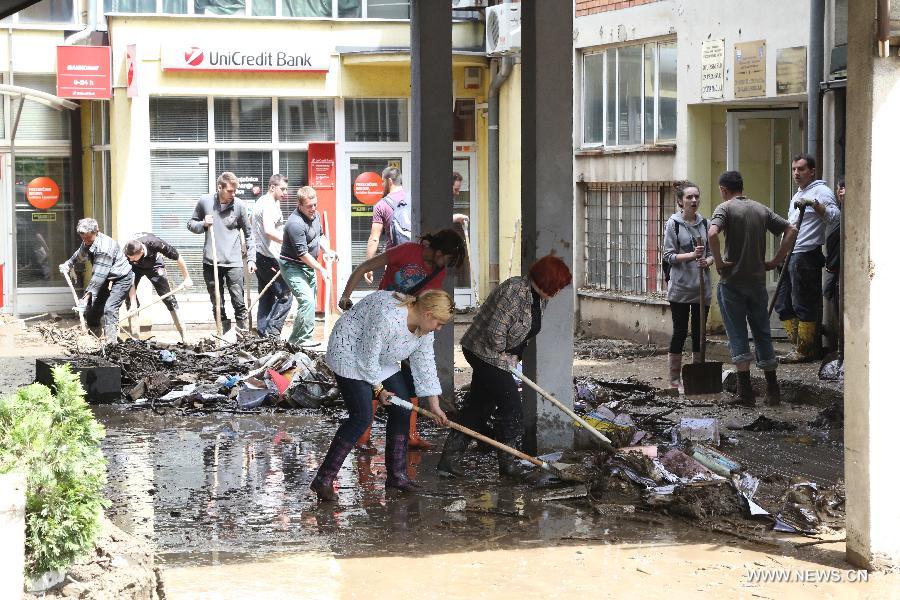 Local residents begin to clean their houses and streets in Maglaj, nearby Doboj, Bosnia-Herzegovina, on May 18, 2014. The flooding, the worst in about 120 years, killed at least 20 people, local media reported. [Photo/Xinhua]