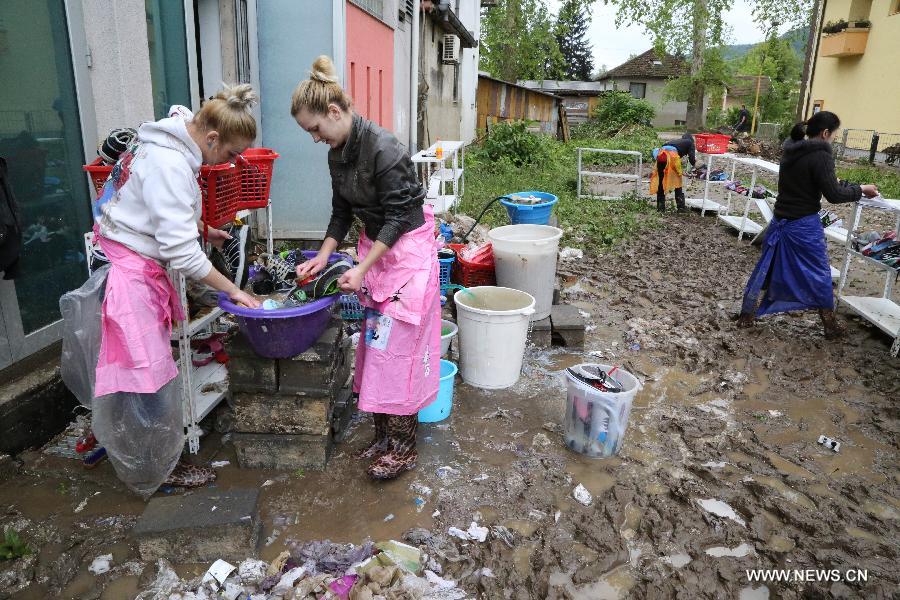 Local residents begin to clean their houses and streets in Maglaj, nearby Doboj, Bosnia-Herzegovina, on May 18, 2014. The flooding, the worst in about 120 years, killed at least 20 people, local media reported. [Photo/Xinhua]