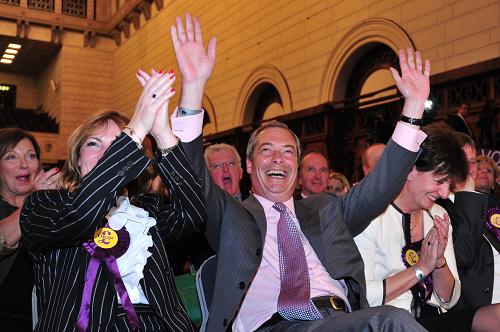 UK Independence Party (UKIP) leader Nigel Farage (C) reacts as the South East England region results of the European Parliament elections are declared by the returning officer at Southampton Guildhall in Southampton, southern England, on May 25, 2014. Farage said his party was on course to cause a political 'earthquake' as it took the lead in the European parliament election in Britain. [Xinhua photo]