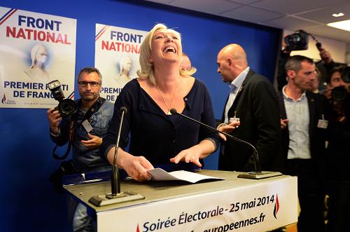 French far-right Front National (FN) party president Marine Le Pen reacts at the party's headquarters in Nanterre, outside Paris, on May 25, 2014. [Xinhua photo]