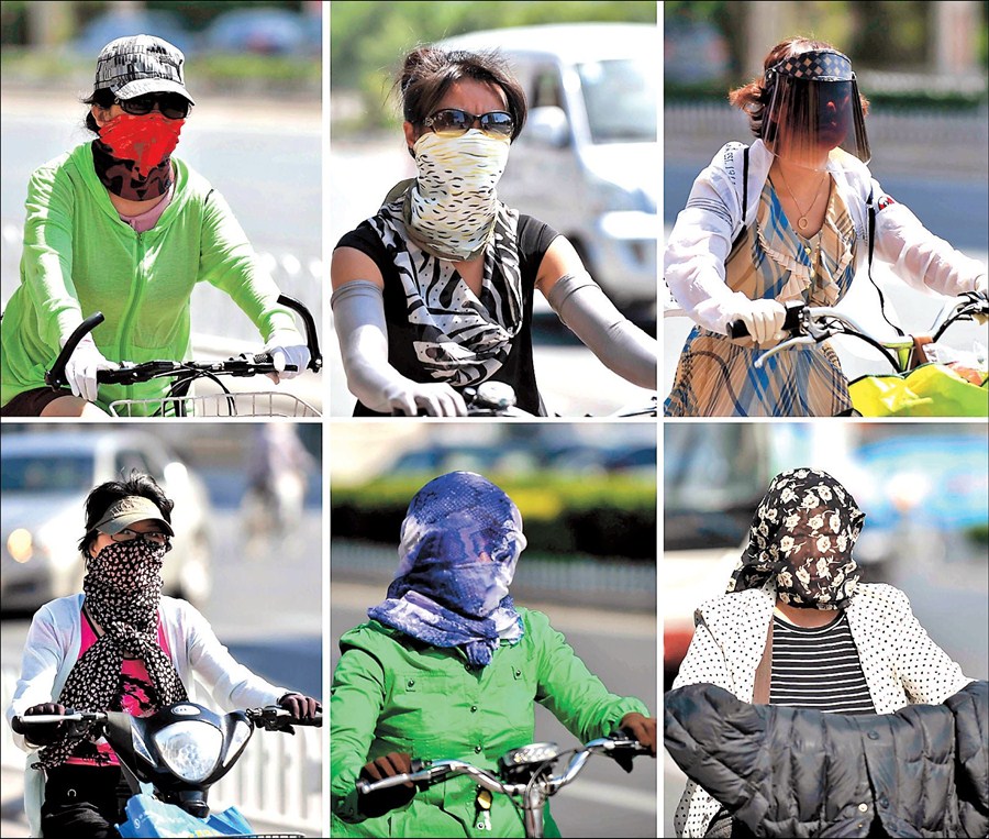 Cyclists in the northern city of Tianjin adopt a variety of tricks to beat the heat yesterday after the mercury hit a record 40.5 degrees Celsius.