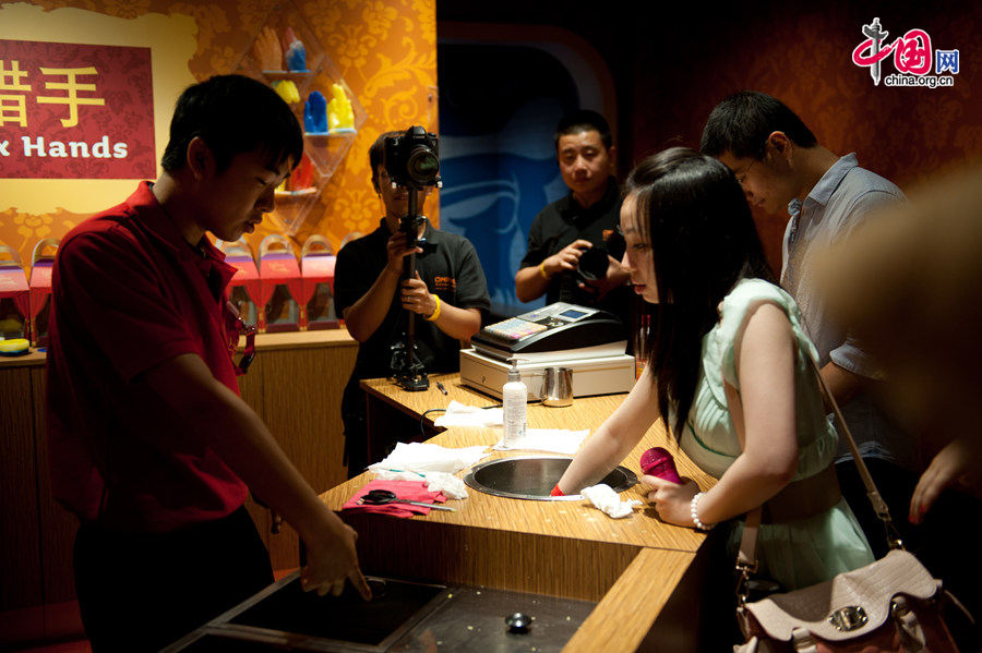 Visitors to Madame Tussauds Beijing experience the process of making a wax model of a hand on Thursday. The wax museum will be officially open to public on May 31, 2014. [Photo by Chen Boyuan / China.org.cn]