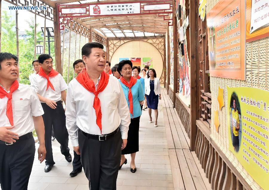 Chinese President Xi Jinping views art works created by pupils during his visit at Beijing Haidian National Primary School in Beijing, capital of China, May 30, 2014. Xi attended an activity to celebrate the upcoming International Children&apos;s Day at the primary school.