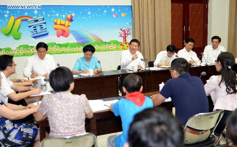 Chinese President Xi Jinping attends a seminar with representatives from teachers, students and parents during his visit at Beijing Haidian National Primary School in Beijing, capital of China, May 30, 2014. Xi attended an activity to celebrate the upcoming International Children&apos;s Day at the primary school. 