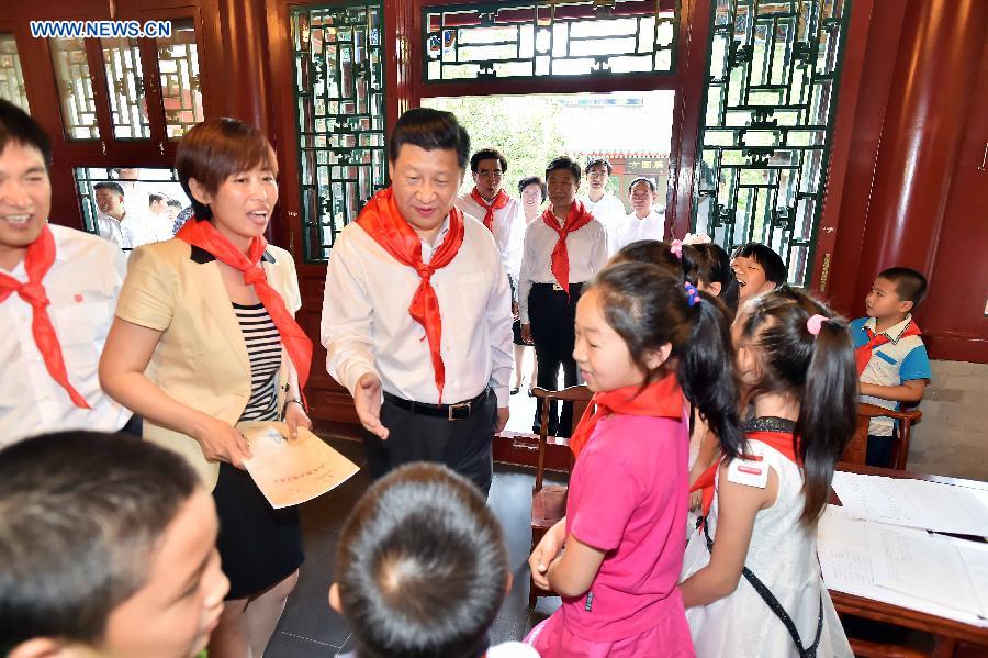 Chinese President Xi Jinping listens to children who are reciting classic Chinese texts during his visit at Beijing Haidian National Primary School in Beijing, capital of China, May 30, 2014. Xi attended an activity to celebrate the upcoming International Children&apos;s Day at the primary school.