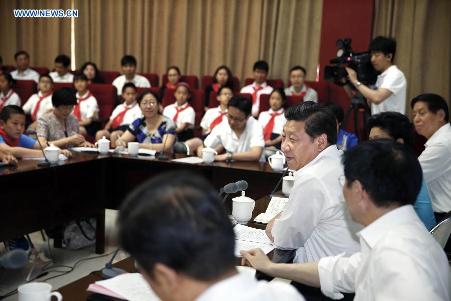 Chinese President Xi Jinping attends a seminar with representatives from teachers, students and parents during his visit at Beijing Haidian National Primary School in Beijing, capital of China, May 30, 2014. Xi attended an activity to celebrate the upcoming International Children&apos;s Day at the primary school. 