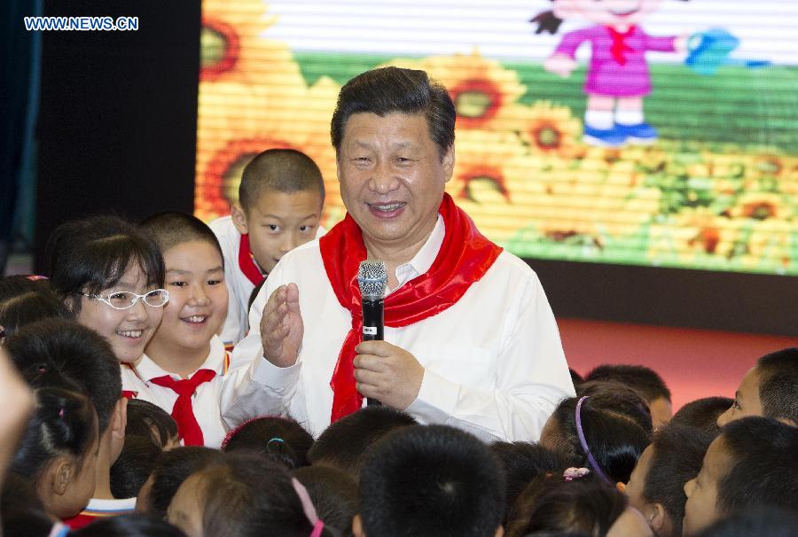 Chinese President Xi Jinping attends an initiation ceremony of Young Pioneers during his visit at Beijing Haidian National Primary School in Beijing, capital of China, May 30, 2014. Xi attended an activity to celebrate the upcoming International Children&apos;s Day at the primary school. 