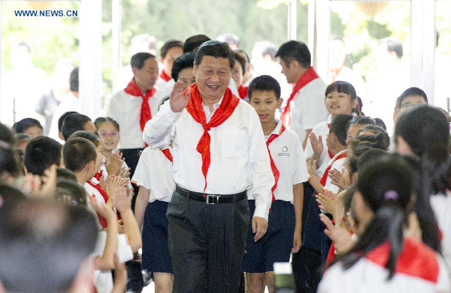 Chinese President Xi Jinping attends an initiation ceremony of Young Pioneers during his visit to Beijing Haidian National Primary School in Beijing, capital of China, May 30, 2014. Xi attended an activity to celebrate the upcoming International Children&apos;s Day at the primary school. 