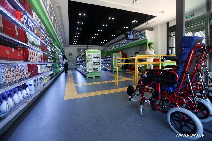 Photo taken on May 30, 2014 shows an accessible supermarket during its soft operation in Shenyang, capital of northeast China&apos;s Liaoning province. The market with barrier-free designs including Braille tags, blind tracks and free loans of wheelchairs, will officially open in June. All employees of the market are disabled people. 