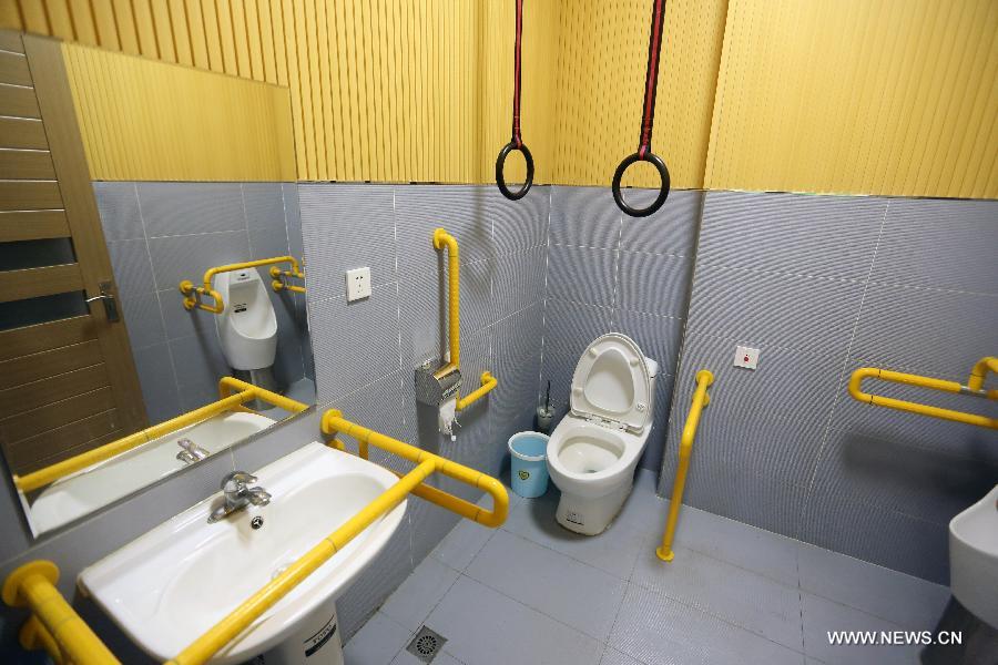Photo taken on May 30, 2014 shows the bathroom with barrier-free facilities at an accessible supermarket in Shenyang, capital of northeast China&apos;s Liaoning province. The market with barrier-free designs including Braille tags, blind tracks and free loans of wheelchairs, will officially open in June. All employees of the market are disabled people. 