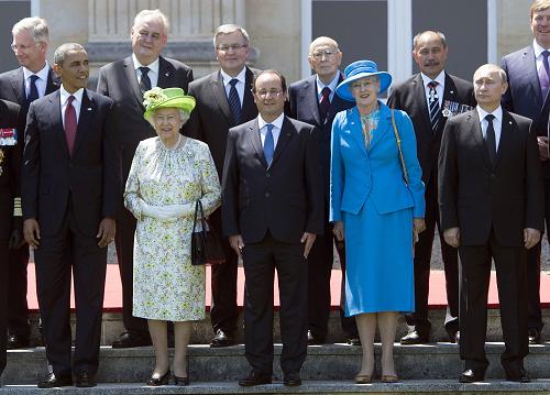  (from L) US President Barack Obama, Queen Elizabeth of Britain, French President Francois Hollande, Queen Margrethe of Denmark and Russian President Vladimir Putin participate in a group photo of world leaders attending the D-Day 70th Anniversary ceremonies at Chateau de Benouville in Benouville, France, June 6, 2014. [Xinhua photo]