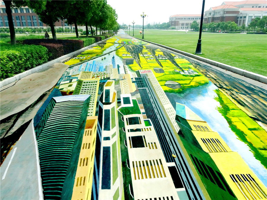 A 3D street painting at the Communication University of China, Nanjing, stretches 365 meters long and is 7.5 meters wide, and occupies over 2,600 square meters, June 11, 2014. [Photo by Wang Luxian/Asianewsphoto]